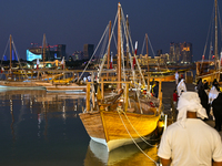 Traditional wooden dhows are on display during the 14th Katara Traditional Dhow Festival in Katara Cultural Village in Doha, Qatar, on Decem...