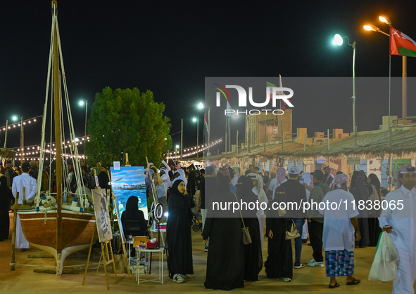 People visit the 14th Katara Traditional Dhow Festival in Katara Cultural Village in Doha, Qatar, on December 5, 2024. The festival celebrat...