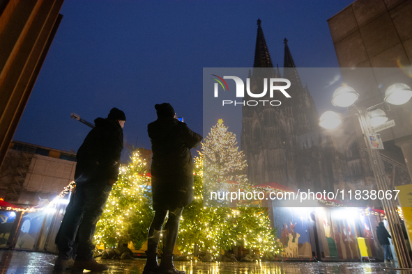 General tourists take pictures at the Cologne Dom Christmas Market in Cologne, Germany, on December 5, 2024. 