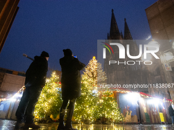 General tourists take pictures at the Cologne Dom Christmas Market in Cologne, Germany, on December 5, 2024. (