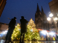 General tourists take pictures at the Cologne Dom Christmas Market in Cologne, Germany, on December 5, 2024. (