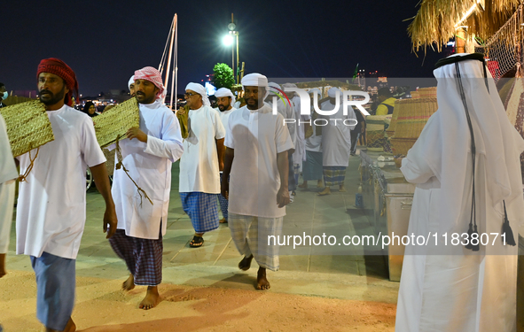 A group of traditional Arabic fishermen performs during the 14th Katara Traditional Dhow Festival in Katara Cultural Village in Doha, Qatar,...