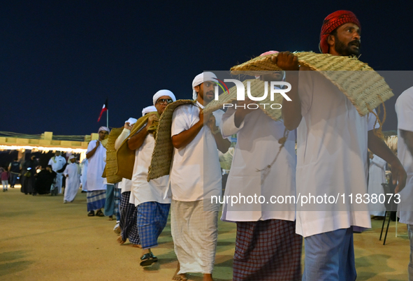 A group of traditional Arabic fishermen performs during the 14th Katara Traditional Dhow Festival in Katara Cultural Village in Doha, Qatar,...