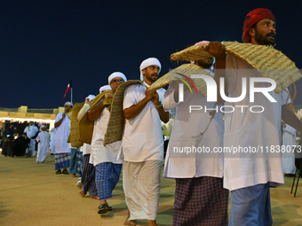 A group of traditional Arabic fishermen performs during the 14th Katara Traditional Dhow Festival in Katara Cultural Village in Doha, Qatar,...