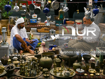 A man makes handicrafts during the 14th Katara Traditional Dhow Festival in Katara Cultural Village in Doha, Qatar, on December 5, 2024. The...