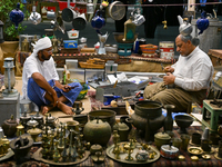 A man makes handicrafts during the 14th Katara Traditional Dhow Festival in Katara Cultural Village in Doha, Qatar, on December 5, 2024. The...