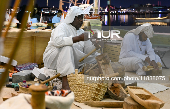 A man makes handicrafts during the 14th Katara Traditional Dhow Festival in Katara Cultural Village in Doha, Qatar, on December 5, 2024. The...