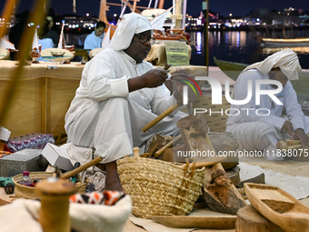 A man makes handicrafts during the 14th Katara Traditional Dhow Festival in Katara Cultural Village in Doha, Qatar, on December 5, 2024. The...