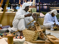 A man makes handicrafts during the 14th Katara Traditional Dhow Festival in Katara Cultural Village in Doha, Qatar, on December 5, 2024. The...