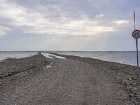 A gravel road by the Wadden Sea bottom connects Jutland and Mando Island. It opens only a few hours daily during low tide due to the high se...