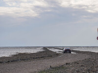 A gravel road by the Wadden Sea bottom connects Jutland and Mando Island. It opens only a few hours daily during low tide due to the high se...