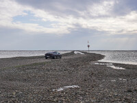 A gravel road by the Wadden Sea bottom connects Jutland and Mando Island. It opens only a few hours daily during low tide due to the high se...