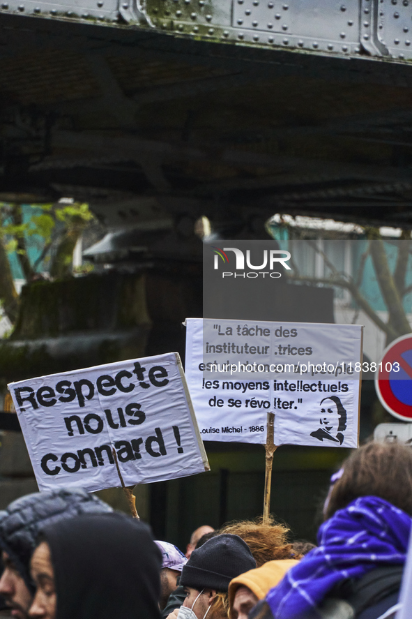 A protester holds signs, in Paris, France, on december 05, 2024. ( Tony Linke/NurPhoto)