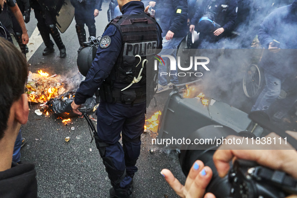 Police put out a dustbin, in Paris, France, on december 05, 2024. ( Tony Linke/NurPhoto)