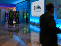 Workers make final preparations at the Doha Forum venue inside the Sheraton Grand Doha Resort & Convention Hotel ahead of the 22nd edition o...