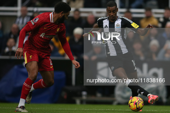 Newcastle United's Alexander Isak takes on Liverpool's Joe Gomez during the Premier League match between Newcastle United and Liverpool at S...