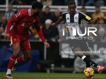 Newcastle United's Alexander Isak takes on Liverpool's Joe Gomez during the Premier League match between Newcastle United and Liverpool at S...