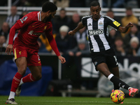 Newcastle United's Alexander Isak takes on Liverpool's Joe Gomez during the Premier League match between Newcastle United and Liverpool at S...