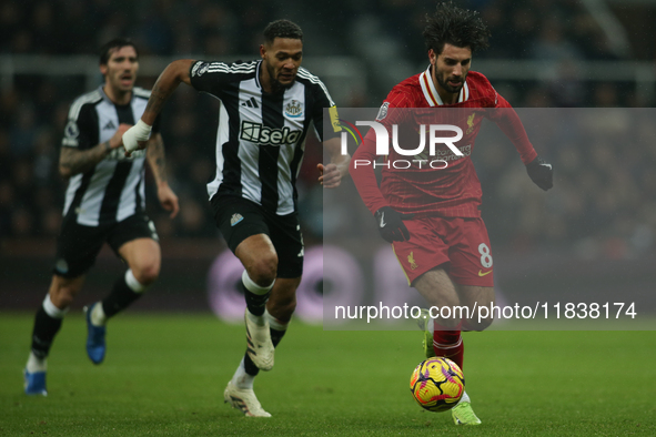 Liverpool's Dominik Szoboszlai breaks away from Newcastle United's Joelinton during the Premier League match between Newcastle United and Li...