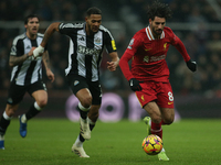 Liverpool's Dominik Szoboszlai breaks away from Newcastle United's Joelinton during the Premier League match between Newcastle United and Li...