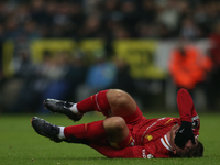 Liverpool's Alexis Mac Allister rolls on the floor during the Premier League match between Newcastle United and Liverpool at St. James's Par...