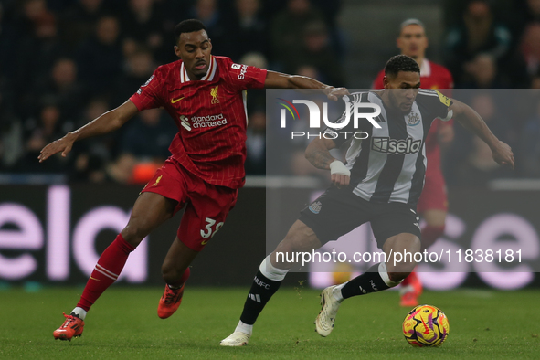 Newcastle United's Joelinton breaks away from Liverpool's Ryan Gravenberch during the Premier League match between Newcastle United and Live...