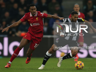 Newcastle United's Joelinton breaks away from Liverpool's Ryan Gravenberch during the Premier League match between Newcastle United and Live...