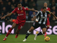 Newcastle United's Joelinton breaks away from Liverpool's Ryan Gravenberch during the Premier League match between Newcastle United and Live...