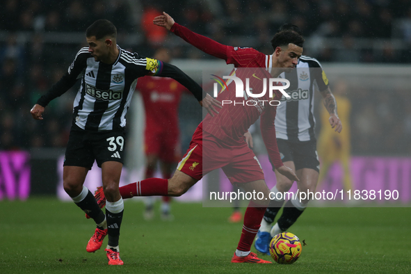 Liverpool's Curtis Jones breaks past Newcastle United's Bruno Guimaraes during the Premier League match between Newcastle United and Liverpo...