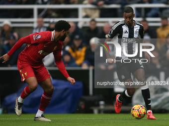 Newcastle United's Alexander Isak takes on Liverpool's Joe Gomez during the Premier League match between Newcastle United and Liverpool at S...