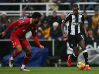 Newcastle United's Alexander Isak takes on Liverpool's Joe Gomez during the Premier League match between Newcastle United and Liverpool at S...