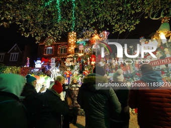 Holiday lights and inflatable characters stand in the front yard of a home in the Dyker Heights section of Brooklyn, N.Y., on December 4, 20...