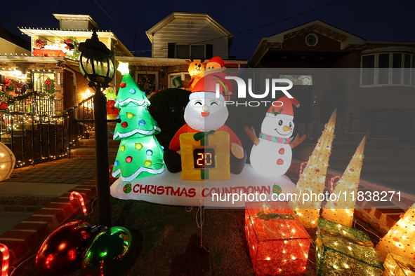 Holiday lights and inflatable characters stand in the front yard of a home in the Dyker Heights section of Brooklyn, N.Y., on December 4, 20...