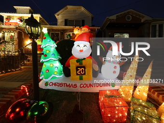 Holiday lights and inflatable characters stand in the front yard of a home in the Dyker Heights section of Brooklyn, N.Y., on December 4, 20...