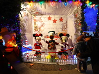 People gather to see and photograph the holiday lights at a home in the Dyker Heights section of Brooklyn, N.Y., on December 4, 2024. Dyker...