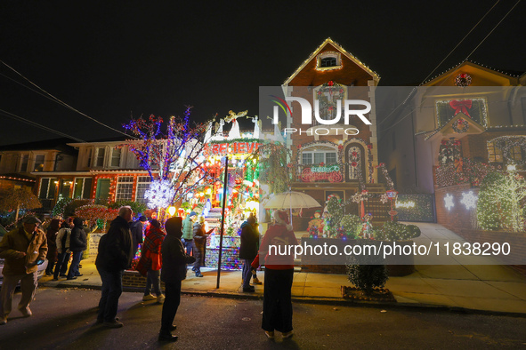 People gather to see and photograph the holiday lights at a home in the Dyker Heights section of Brooklyn, N.Y., on December 4, 2024. Dyker...