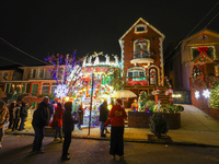 People gather to see and photograph the holiday lights at a home in the Dyker Heights section of Brooklyn, N.Y., on December 4, 2024. Dyker...