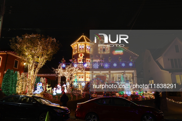 People gather to see and photograph the holiday lights at a home in the Dyker Heights section of Brooklyn, N.Y., on December 4, 2024. Dyker...