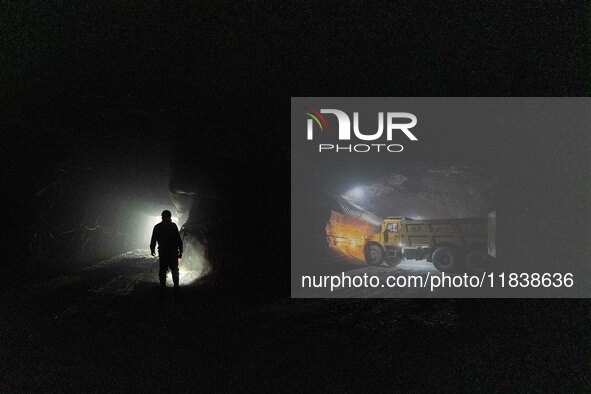 Workers load mined phosphate rocks into trucks at the plant of the Ferriichong phosphate mine in Hualuo village, Sanjia street, Zhijin Count...