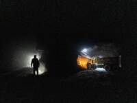 Workers load mined phosphate rocks into trucks at the plant of the Ferriichong phosphate mine in Hualuo village, Sanjia street, Zhijin Count...