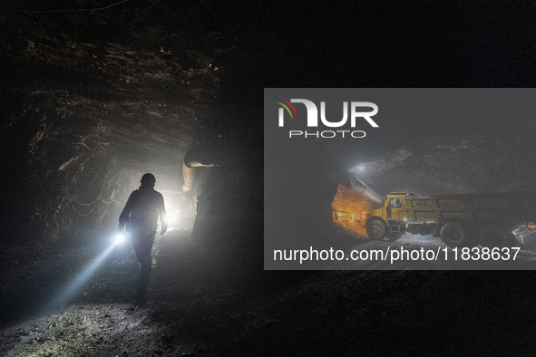 Workers load mined phosphate rocks into trucks at the plant of the Ferriichong phosphate mine in Hualuo village, Sanjia street, Zhijin Count...