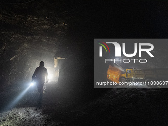 Workers load mined phosphate rocks into trucks at the plant of the Ferriichong phosphate mine in Hualuo village, Sanjia street, Zhijin Count...