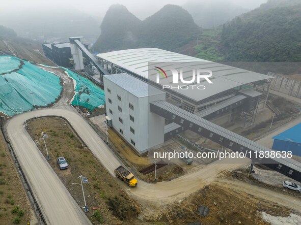 Workers transport phosphate rock by truck at the plant of the Ferriichong phosphate mine in Hualuo village, Sanjia street, Zhijin County, in...