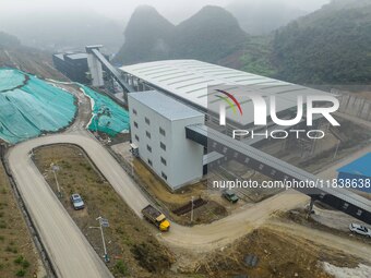 Workers transport phosphate rock by truck at the plant of the Ferriichong phosphate mine in Hualuo village, Sanjia street, Zhijin County, in...