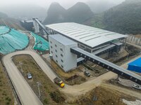 Workers transport phosphate rock by truck at the plant of the Ferriichong phosphate mine in Hualuo village, Sanjia street, Zhijin County, in...