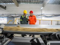 Workers carry out a routine inspection on a conveyor belt at the Ferris Chong phosphate mine in Hualuo village, Sanjia street, Zhijin County...