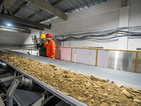 Workers carry out a routine inspection on a conveyor belt at the Ferris Chong phosphate mine in Hualuo village, Sanjia street, Zhijin County...