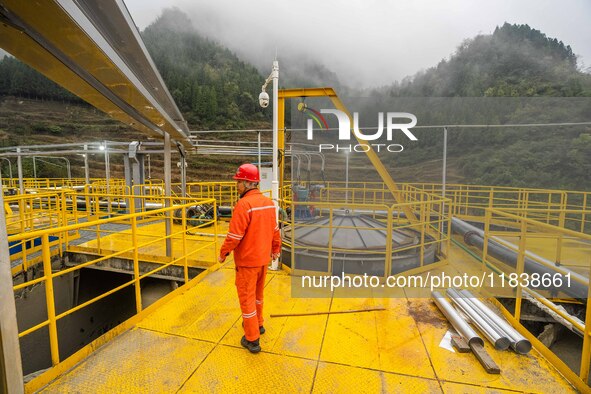 Workers carry out routine inspections on the facilities and equipment of the Ferriichong phosphate mine in Hualuo Village, Sanjia Street, Zh...