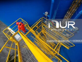 Workers carry out routine inspections on the facilities and equipment of the Ferriichong phosphate mine in Hualuo Village, Sanjia Street, Zh...