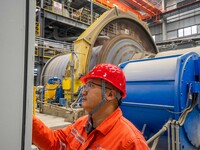 Workers carry out routine inspections on the facilities and equipment of the Ferriichong phosphate mine in Hualuo Village, Sanjia Street, Zh...